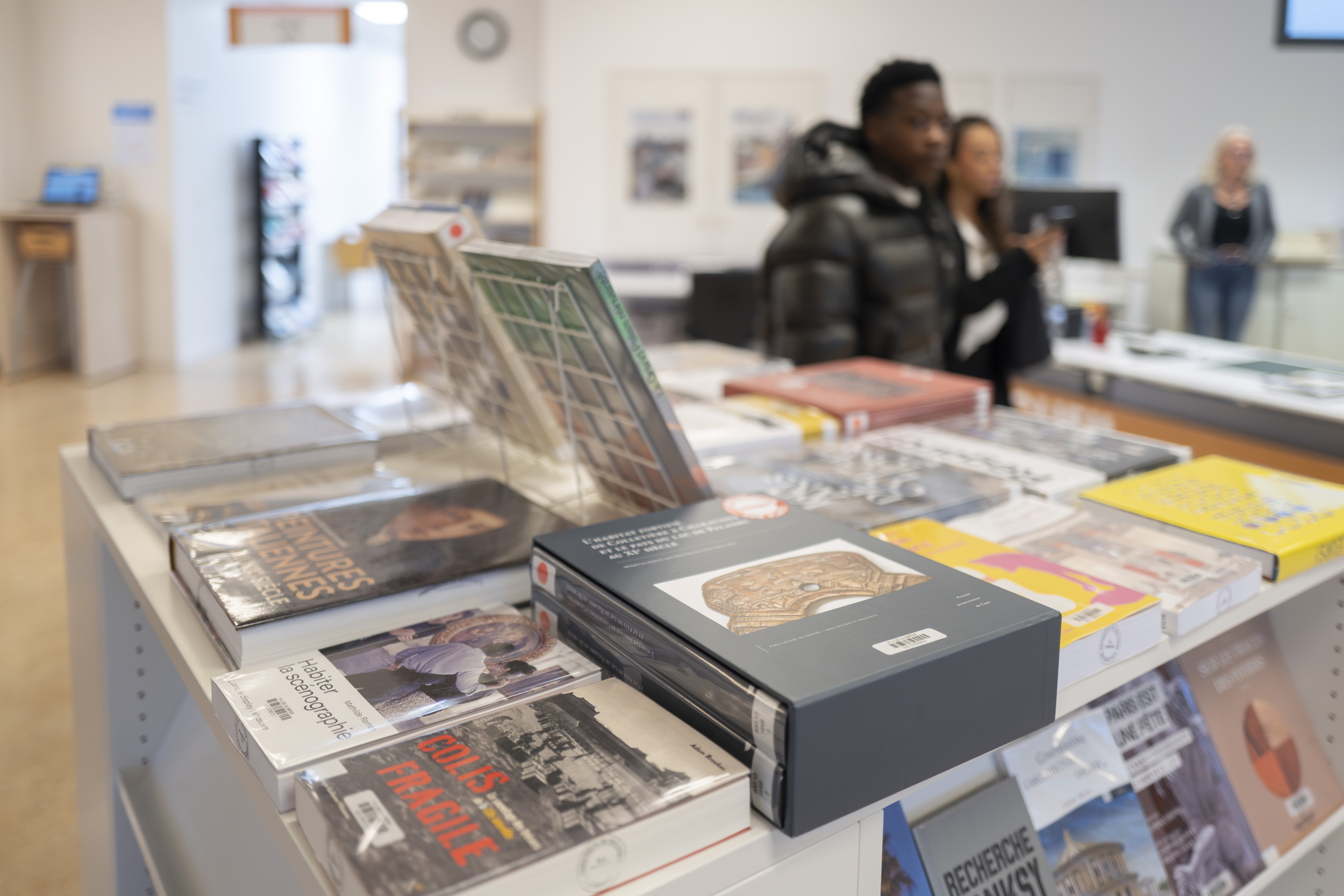 Un étudiant marche à côté d'un présentoir de la bibliothèque